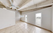 Located at 5405 SW 34th St in Pembroke Park, Florida, this single-story, one-bedroom, two-bathroom home offers a practical and functional layout across a compact but well-utilized footprint. The combined living, dining, and kitchen area forms the heart of the home, featuring striking vaulted ceilings with exposed wooden beams and a ceiling fan that enhances airflow throughout the space. Light-toned ceramic tile flooring runs consistently throughout, lending a clean and cohesive look. Multiple windows allow natural light to brighten the open living area.

The kitchen is equipped with white cabinetry offering ample storage, a stainless steel sink, electric range, refrigerator, and a dishwasher, all set beneath the soaring ceiling that extends from the main living space. The bedroom is a generously sized private retreat featuring a built-in closet with louvered bifold doors and a window that admits natural light, complemented by a textured ceiling. Two bathrooms serve the home, one of which includes a vanity with a built-in cabinet, a wall mirror, and a separate toilet compartment, finished in light, neutral tones. A dedicated utility room and two closets provide additional storage. The consistent tile flooring, bright neutral walls, and functional layout make this home a well-organized and comfortable single-floor residence.