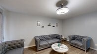 Located at 502 Kemp Blvd in Wichita Falls, TX, this efficient one-bedroom, one-bathroom unit offers a thoughtfully designed layout across a single floor. The living room is a standout space, featuring warm wood-look flooring, soft gray walls, and a sleek retractable ceiling fan with integrated lighting. A galley-style kitchen is outfitted with dark cabinetry, granite-look countertops, a double basin sink, and black appliances, providing a functional and cohesive aesthetic. The open living and dining area benefits from natural light through vertical-blind-covered sliding doors, creating a bright and welcoming atmosphere. The bedroom is carpeted for comfort, includes a ceiling fan, a window with blinds and drape panels, and direct access to one of three closets, offering generous storage throughout the unit. The bathroom features a dark vanity base with a granite-look countertop, a large mirror, and well-placed lighting. Consistent neutral tones and modern fixtures tie the space together, creating a clean, contemporary feel throughout. With three closets distributed across the unit, storage is a practical highlight of this well-appointed Wichita Falls residence.