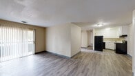 Located at 5408 N Nevada Ave in Colorado Springs, Colorado, this single-floor, three-bedroom, two-bathroom home offers a practical and comfortable layout. The open living area features wood-style laminate flooring and neutral-toned walls with a textured ceiling, creating a clean and functional space. A sliding glass door provides access to the outdoors and allows natural light to flow in. The kitchen is efficiently designed with white cabinetry offering ample storage, light countertops, and black appliances including a refrigerator, electric range, dishwasher, and an overhead range hood. The three bedrooms are carpeted for comfort, with each room featuring ceiling-mounted light fixtures, including a ceiling fan in at least one bedroom, and windows dressed with blinds that bring in natural light. The primary bedroom provides a comfortable, well-proportioned space. Two full bathrooms serve the home — one features a vanity with a light stone-top, mirrored medicine cabinet, and wood-style flooring, while the other includes a full tub and tile surround. A hallway and closet complete the interior layout, contributing to practical everyday living in this straightforward and well-maintained Colorado Springs home.