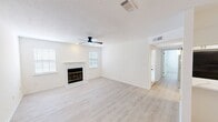 Located at 9000 W Wilderness Way in Shreveport, Louisiana, this single-story, 2-bedroom, 2-bathroom home offers a clean and modern interior designed for comfortable living. Light wood-tone flooring runs throughout the space, complementing the crisp white walls and creating a bright, cohesive aesthetic.

The living room serves as the heart of the home, featuring a classic fireplace flanked by two windows that allow natural light to fill the room. A ceiling fan adds both style and function overhead, and a textured ceiling provides subtle visual interest.

The kitchen is efficiently laid out with white cabinetry, light stone countertops, black hardware accents, and stainless steel appliances including a range, microwave, and refrigerator. A set of double doors provides access to a pantry or storage area, maximizing the kitchen's utility.

Both bedrooms are well-sized and bright, each equipped with ceiling fans and windows fitted with blinds. The primary bedroom features a spacious double closet, while the second bedroom offers dual closets with ample hanging storage. The bathrooms are finished with white vanities, marble-look countertops, undermount sinks, matte black fixtures, framed mirrors, and wall-mounted medicine cabinets — delivering a cohesive, contemporary look throughout.