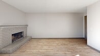 Located at 1877 El Rancho Dr in Sparks, Nevada, this single-story, 3-bedroom, 2-bathroom home offers a functional and updated layout throughout. The living room serves as a central gathering space, highlighted by a classic brick fireplace with a raised hearth and sliding glass doors that invite natural light and provide outdoor access. Wood-style flooring runs throughout the home, creating a cohesive and easy-to-maintain aesthetic.

The kitchen is well-appointed with gray cabinetry, white countertops, stainless steel appliances including an electric range and dishwasher, and a peninsula that provides additional workspace and a natural division between the kitchen and living areas.

The three bedrooms are comfortably sized, with the primary bedroom offering generous closet space. Each bedroom features wood-style flooring, neutral walls, and windows that bring in natural light. Textured ceilings are present throughout much of the home.

The two bathrooms are clean and functional. One features a single-sink vanity with white countertop and a walk-in shower, while the second includes a shower-tub combo. Both bathrooms maintain a bright, neutral palette with light wood-style flooring. Overall, the home presents a practical and move-in ready living environment.
