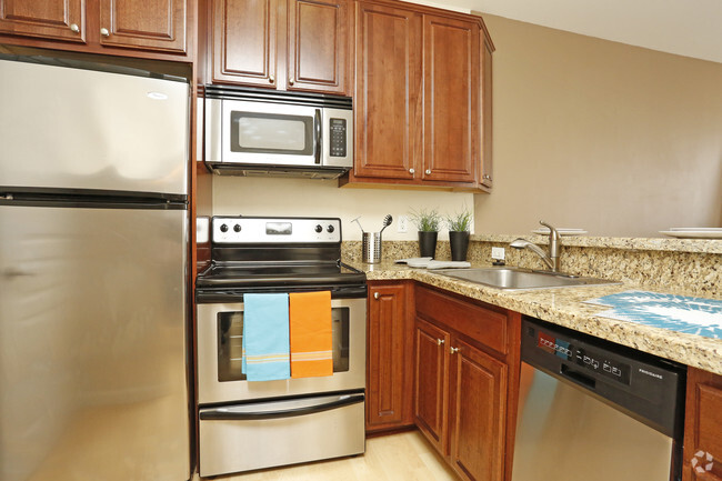 Upgraded kitchen with granite and stainless steel - Metropolitan Collection Apartments