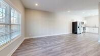 Located at 2500 Tiny Town Rd in Clarksville, Tennessee, this two-story home offers three bedrooms and three bathrooms across two well-proportioned floors. The main level features an open-concept kitchen and living area finished with light luxury vinyl plank flooring and recessed lighting. The kitchen is equipped with stainless steel appliances — including a French door refrigerator, electric range, built-in microwave, and dishwasher — complemented by white shaker-style cabinetry and granite countertops. Natural light fills the space through windows dressed with horizontal blinds, and a exterior door provides convenient access from the kitchen area. The bathrooms are finished with wood-look LVP flooring, white vanities, and full tub-shower combinations with brushed nickel fixtures and built-in shelving. The upper level houses the bedrooms, each featuring plush carpet, ceiling fans with light fixtures, and windows that bring in ample natural light. The primary bedroom offers a comfortable, well-sized retreat. Two closets provide dedicated storage throughout the home. Neutral warm-gray tones and clean white trim carry throughout, giving the home a cohesive, move-in-ready aesthetic.