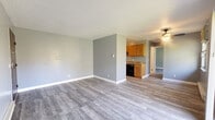 Located at 6714 Harrison Ave in Cincinnati, Ohio, this one-bedroom, one-bathroom unit offers a well-organized, single-floor layout with a clean, modern aesthetic. Throughout the space, light gray luxury vinyl plank flooring provides a cohesive and durable foundation, complemented by neutral gray walls and crisp white baseboards and trim.

The open living area is spacious and bright, featuring a ceiling fan, a window unit for climate control, baseboard heating, and a large sliding glass door that opens directly onto a private balcony overlooking a natural, wooded setting — a standout feature of the unit. The balcony brings abundant natural light into the living space and offers a peaceful outdoor retreat.

The kitchen is efficiently laid out with warm-toned wood cabinetry, a black range, and granite-style countertops, positioned adjacent to the living area for an open feel. The bedroom is a comfortable size, offering a natural window view of the surrounding trees, baseboard heating, and a large sliding double-door closet for ample storage. A second closet elsewhere in the unit provides additional storage capacity.

The bathroom features tile flooring, a dark wood vanity with a white countertop, and a full tub-shower combination. The textured ceilings are consistent throughout, adding a classic finishing touch to this well-maintained and move-in-ready unit.