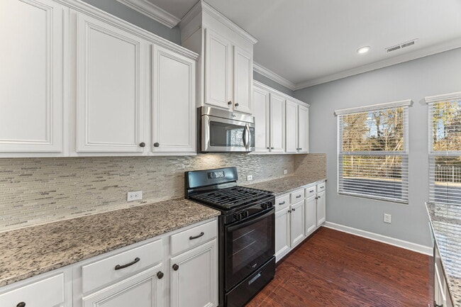 Building Photo - Classic finishes paired with an open, versatile layout!