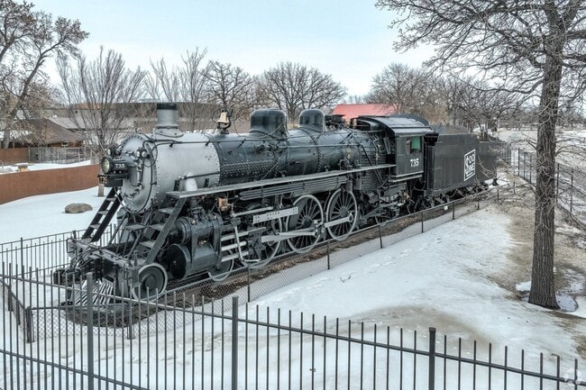 Historic Soo Line steam locomotive on outdoor display in snowy Minot, ND