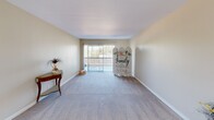 Located at 7860 Valley View St in Buena Park, California, this single-floor residence offers 2 bedrooms, 3 bathrooms, and a practical layout designed for comfortable everyday living. The living room features soft carpeting, neutral walls, and a sliding glass door that floods the space with natural light while providing access to an outdoor area. The open sightline from the living room to the kitchen creates a connected, airy feel throughout the common areas. The kitchen is equipped with white shaker-style cabinetry, granite-look countertops, wood-look flooring, and stainless steel appliances including a range and over-the-range microwave. Both bedrooms are carpeted and feature vertical blinds that allow for adjustable natural light, with the primary bedroom offering a dedicated closet. Each bedroom has access to well-appointed bathrooms featuring white vanity cabinetry, granite-look countertops, large mirrors with overhead lighting, and wood-look flooring. One bathroom includes a tub-shower combo with sliding glass doors. Two hallways and two closets provide additional storage and circulation throughout the unit. The space maintains a clean, neutral palette throughout, offering a move-in ready environment in a convenient Southern California location.