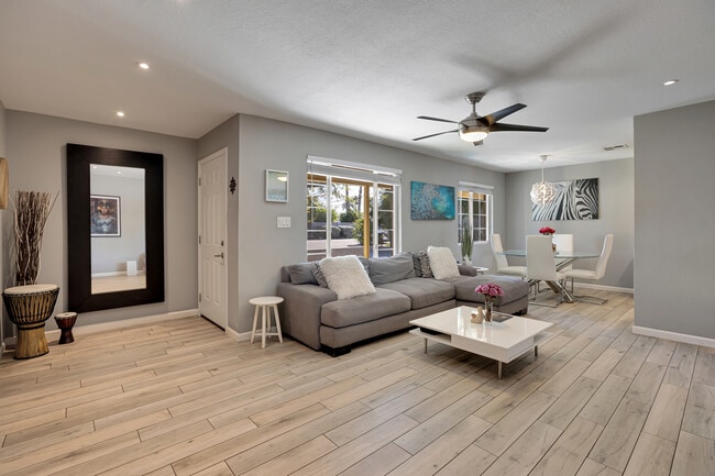 Bright, spacious living room with contemporary finishes and porcelain tile flooring - 6136 N 9th St