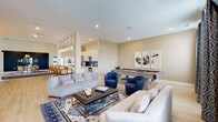 Located at 4900 Gender Rd in Columbus, Ohio, this single-story Ardent Communities clubhouse serves as a well-appointed community gathering space designed with a modern, sophisticated aesthetic. The entrance greets visitors with a bright, open corridor featuring light hardwood flooring, white structural columns, and a branded runner leading to a staffed reception desk. Large glass double doors and transom windows flood the entry with natural light, creating an inviting first impression.

The central lounge area is a versatile, open-plan space anchored by plush sofas, blue accent chairs, a tufted leather ottoman, and a full-size billiards table. Recessed lighting and large windows with decorative drapery contribute to a relaxed yet stylish atmosphere. This area flows seamlessly into a well-equipped kitchen featuring white cabinetry, stainless steel appliances, a spacious countertop island, and pendant lighting — ideal for community events and gatherings.

A dedicated media room, finished in deep navy with warm wall sconces, comfortable sectional seating, woven ottomans, and a large wall-mounted television, offers a cozy theater-like experience complete with a classic popcorn machine. Nearby, a private meeting or dining room makes a bold design statement with dark navy walls, a striking gold pendant light, a round white table, and rattan chairs — a refined space suited for presentations or intimate gatherings.