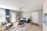 This single-story, 3-bedroom, 2-bathroom home in Baton Rouge, Louisiana offers a thoughtfully designed layout with comfortable living spaces throughout. The open living room is bright and welcoming, featuring plush carpet, a ceiling fan, and natural light streaming through large windows dressed with blinds. A hallway pass-through connects the living area to the kitchen, creating a convenient flow between spaces.

The galley-style kitchen is a standout feature, showcasing white shaker cabinetry, granite countertops, a subway tile backsplash, and wood-look flooring. Black appliances — including a gas range, microwave, and refrigerator — add a bold contrast, and an adjacent laundry area adds everyday convenience.

The generously sized primary bedroom offers plush carpeting, a ceiling fan, and a window for natural light. The two bathrooms are finished with granite countertops, white cabinetry, and wood-look flooring — one featuring a wide vanity with a large mirror and a shower/tub combo. Two additional bedrooms provide flexible space for various needs.

Neutral gray walls, textured ceilings, and consistent finishes throughout give the home a cohesive, move-in-ready feel. A central hallway connects all rooms efficiently, completing this practical and comfortable single-floor layout.