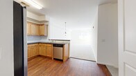 This well-appointed two-bedroom, two-bathroom residence in Brick, NJ offers a thoughtfully designed single-floor layout. The open-concept kitchen and living area serves as the heart of the home, where rich hardwood-style flooring flows throughout the kitchen. Warm maple cabinetry pairs with dark countertops and a classic tile backsplash, while a full suite of stainless steel appliances — including a gas range, built-in microwave, dishwasher, and a large side-by-side refrigerator — provides excellent functionality. A pendant light fixture anchors the kitchen-to-living transition, and the spacious living area features plush neutral carpeting that extends toward the entrance. Both bedrooms are generously sized, carpeted for comfort, and filled with natural light from large windows offering exterior views of the surrounding community. The expansive primary bedroom provides ample space for a full furniture arrangement. Each bathroom is finished with warm wood-toned vanity cabinetry, light tile flooring, and clean white walls. The primary bath features a glass-enclosed shower stall, while the second bathroom offers a similar clean aesthetic. A dedicated entrance area completes the layout, providing a welcoming transition into this bright and functional home.