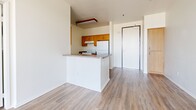 Located at 38832 Fourth St E in Palmdale, CA, this single-floor, two-bedroom, two-bathroom unit offers a well-organized and functional layout. Throughout the home, wood-look vinyl flooring provides a clean, cohesive aesthetic that ties each room together.

The kitchen is designed in a galley style, featuring warm honey-toned wood cabinetry on both sides, dark laminate countertops, a double-basin sink, and white appliances including a range and refrigerator. A peninsula counter opens toward the living area, providing a natural transition between the kitchen and main living space, which is bright and open with neutral white walls.

Both bedrooms feature light-toned wood-look flooring and white walls that maximize the sense of brightness. The primary bedroom offers a comfortable footprint with a dedicated closet, while the second bedroom benefits from a large window that invites natural light and outdoor views. Each bedroom is served by its own dedicated closet for added storage.

The two bathrooms reflect a consistent design language: warm wood vanity cabinetry, dark countertops, and wood-look flooring. One bathroom includes a glass-enclosed shower stall, while the second features a full tub-shower combination with a curved curtain rod. Both are clean, functional, and well-appointed.