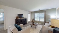 Located at 1 Avalon Way in Shrewsbury, Massachusetts, this single-floor residence offers a thoughtfully designed layout with comfortable, contemporary living spaces throughout. The living room is bright and welcoming, featuring large windows that allow ample natural light to fill the carpeted space, complemented by a private exterior door that adds convenience and connectivity to the outdoors. A dedicated dining area sits adjacent to the living room, finished with plush carpeting and track lighting overhead, creating an intimate setting for meals and gatherings. The galley-style kitchen is well-equipped with white cabinetry, granite-look countertops, stainless steel appliances including a gas range, refrigerator, dishwasher, and microwave, all set atop rich hardwood-style flooring. Two generously sized bedrooms each feature large windows with outdoor views, soft carpeting, and ample room for furnishings. The bathrooms are finished with white vanity cabinetry, granite-look countertops, and durable hardwood-style flooring. One full bathroom includes a shower-tub combination, while a second bathroom provides additional convenience. The overall design palette of neutral tones and clean finishes creates a cohesive, modern ambiance throughout the residence.