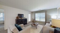 Located at 1 Avalon Way in Shrewsbury, Massachusetts, this single-floor residence offers a thoughtfully designed layout with comfortable, contemporary living spaces throughout. The living room is bright and welcoming, featuring large windows that allow ample natural light to fill the carpeted space, complemented by a private exterior door that adds convenience and connectivity to the outdoors. A dedicated dining area sits adjacent to the living room, finished with plush carpeting and track lighting overhead, creating an intimate setting for meals and gatherings. The galley-style kitchen is well-equipped with white cabinetry, granite-look countertops, stainless steel appliances including a gas range, refrigerator, dishwasher, and microwave, all set atop rich hardwood-style flooring. Two generously sized bedrooms each feature large windows with outdoor views, soft carpeting, and ample room for furnishings. The bathrooms are finished with white vanity cabinetry, granite-look countertops, and durable hardwood-style flooring. One full bathroom includes a shower-tub combination, while a second bathroom provides additional convenience. The overall design palette of neutral tones and clean finishes creates a cohesive, modern ambiance throughout the residence.