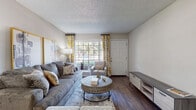 This single-story, 2-bedroom, 1-bathroom residence in Memphis, Tennessee offers a thoughtfully designed layout with consistent wood-style flooring throughout. The living room serves as the heart of the home, featuring a textured ceiling, a large window that fills the space with natural light, and a welcoming, open feel. Adjacent to the living area, the dedicated dining space provides a seamless transition into the galley-style kitchen, which is outfitted with white shaker cabinetry, dark countertops, a tile backsplash, and black appliances including a refrigerator, range, and dishwasher — all illuminated by recessed lighting. The primary bedroom is a serene retreat with wide windows dressed in floor-length curtains, warm neutral tones, and ample space. The second bedroom also benefits from natural light through large windows fitted with vertical blinds, making it a versatile and comfortable room. The full bathroom features a tub-shower combination and wood-style flooring that ties into the rest of the home. Throughout the residence, neutral wall tones, consistent flooring, and abundant natural light create a cohesive and inviting atmosphere well-suited for comfortable everyday living.