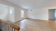 Located at Westridge Gardens in Phoenixville, PA, this well-appointed 2-bedroom, 3-bathroom home offers a thoughtfully designed single-floor layout. The open-concept living area features light hardwood-style flooring, bright white walls, and a classic wood-burning fireplace that serves as a focal point of the space. Natural light flows in through windows that frame lush, wooded outdoor views, creating a peaceful and private ambiance.

The kitchen is equipped with gray shaker-style cabinetry, dark granite countertops, stainless steel appliances including a refrigerator, range, and microwave, and a peninsula with pendant lighting overhead—ideal for casual dining or entertaining. The kitchen connects seamlessly to the living area via hardwood-style flooring that extends throughout the main living spaces.

Both bedrooms are carpeted and feature generous closet storage, with the primary bedroom offering two closets and comfortable proportions. The three bathrooms are clean and functional, finished in bright white with tiled flooring; one features a tub-shower combination. A hallway connects the key living areas efficiently. Outside, mature trees and lush greenery provide a tranquil natural backdrop to this Phoenixville residence.