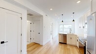 Located at 901 Leland St in Philadelphia's vibrant Art Museum neighborhood, this thoughtfully designed one-bedroom unit offers a clean, modern aesthetic throughout. Light-toned hardwood flooring flows seamlessly across the entire space, complemented by crisp white walls and recessed lighting that create a bright, airy atmosphere.

The open-concept kitchen and living area serves as the heart of the unit. The kitchen is well-appointed with white shaker-style cabinetry, a marble-look tile backsplash, quartz countertops, and a full suite of stainless steel appliances including a French door refrigerator, electric range, built-in microwave, and dishwasher. A peninsula with an integrated sink provides additional workspace and casual seating potential, while two matte black pendant lights add a contemporary design touch.

The bedroom is a comfortable, well-proportioned room with a large sliding-door closet, recessed lighting, and a window that allows natural light to filter in. The bathroom features marble-style tile in the shower/tub surround, matte black fixtures and hardware, and a clean white vanity. Additional storage is provided by three closets throughout the unit. In-unit laundry adds everyday convenience. The overall design is modern, cohesive, and move-in ready.