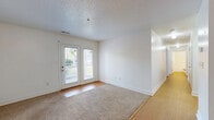 Located at 100 Ridgewood Ln in Radford, Virginia, this single-floor, 3-bedroom, 2-bathroom home offers a well-organized and functional layout. The living area features warm wood-tone flooring and plush carpet, with a set of glass panel doors that invite natural light and provide direct access to the outdoors. A pendant light fixture anchors the dining area, which flows seamlessly into the kitchen via a pass-through opening. The kitchen is equipped with warm oak cabinetry, white countertops, a coil-top electric range, and a dishwasher, providing ample storage and workspace. The three bedrooms are carpeted and bright, each featuring windows that bring in natural light and views of the surrounding neighborhood. The spacious primary bedroom includes its own closet, while additional closets throughout the home provide generous storage. The two bathrooms are clean and functional — one features tile flooring, an oak vanity with a white countertop, and a walk-in shower, while the second includes a full tub-shower combination. Textured ceilings are present throughout, adding a classic finishing touch. The home's neutral color palette and practical design make it a comfortable and welcoming space in the Radford community.