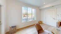 Located at 8005 NE 13th Ave in Vancouver, WA, this well-appointed 2-bedroom, 2-bathroom unit offers a thoughtfully designed single-floor layout. The open-concept living, dining, and kitchen area serves as the heart of the home, featuring light hardwood flooring throughout and recessed lighting. The living room includes a sleek built-in electric fireplace, a wall-mounted TV nook, and large windows and a glass door leading to a private balcony, filling the space with natural light. The kitchen is outfitted with gray shaker-style cabinetry, quartz countertops, a white subway tile backsplash, a center island, and a full suite of stainless steel appliances including a gas range, microwave, dishwasher, and refrigerator. Both bathrooms feature clean, neutral finishes, with one offering a full tub-shower combination and a vanity with quartz countertops and tile flooring. The primary bedroom includes a wall-mounted mini-split system for climate control and plush carpeting, while the second bedroom benefits from a large picture window with outdoor views. Additional highlights include four closets for generous storage and a dedicated in-unit laundry area, making this a highly functional and modern living space.