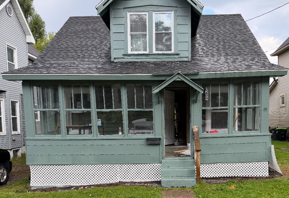 Enclosed porch front and deck in back - 1209 Tweed St