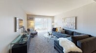 Located at 1147 Briarbrook Dr in Wheaton, Illinois, this single-floor residence offers a well-organized and comfortable layout designed for everyday living. The living room is a generous, light-filled space anchored by plush carpeting and a large sliding glass door with vertical blinds that invites abundant natural light and provides views to the outdoors. The open-concept kitchen is equipped with white cabinetry, granite-style countertops, a gas range, built-in microwave, and a dishwasher. Track lighting overhead and a peninsula counter seamlessly connect the kitchen to a dedicated dining area, which features warm hardwood-style flooring — a practical and stylish transition between spaces. The bedrooms are carpeted and serene, each offering closet storage and windows that bring in natural light. One bedroom conveniently houses an in-unit stacked washer and dryer. The full bathroom is finished with tile flooring, a tub-shower combination, a vanity with storage, and clean, neutral tones throughout. The overall design of the residence balances functional living with a warm, inviting ambiance, making it a practical and comfortable home in the Wheaton community.