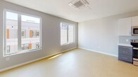 Located at 121 N Second St in Philadelphia's historic Old City neighborhood, this single-floor unit offers a thoughtfully designed, modern living space with a clean and minimalist aesthetic. Light-toned flooring flows throughout, complementing the bright, neutral color palette found in every room.

The entry hallway is clean and functional, featuring recessed lighting, a louvered storage closet, and a wall-mounted panel, leading seamlessly into the main living areas. The open kitchen is well-appointed with two-tone cabinetry — crisp white upper cabinets paired with slate-gray lower cabinets — set against a light tile backsplash. White countertops and a full suite of stainless steel appliances, including a refrigerator, electric range, microwave, and dishwasher, complete the space. A barn-style sliding door adds a contemporary architectural touch along the main corridor.

The living area benefits from multiple windows that invite generous natural light and offer views of the surrounding urban neighborhood. A ceiling-mounted HVAC unit ensures year-round comfort.

The bathroom is finished with large-format dark tile flooring, gray cabinetry with brushed nickel hardware, a white countertop with an undermount sink, and a full soaking tub with shower. The overall design of the space is cohesive, modern, and move-in ready.
