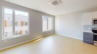 Located at 121 N Second St in Philadelphia's historic Old City neighborhood, this single-floor unit offers a thoughtfully designed, modern living space with a clean and minimalist aesthetic. Light-toned flooring flows throughout, complementing the bright, neutral color palette found in every room.

The entry hallway is clean and functional, featuring recessed lighting, a louvered storage closet, and a wall-mounted panel, leading seamlessly into the main living areas. The open kitchen is well-appointed with two-tone cabinetry — crisp white upper cabinets paired with slate-gray lower cabinets — set against a light tile backsplash. White countertops and a full suite of stainless steel appliances, including a refrigerator, electric range, microwave, and dishwasher, complete the space. A barn-style sliding door adds a contemporary architectural touch along the main corridor.

The living area benefits from multiple windows that invite generous natural light and offer views of the surrounding urban neighborhood. A ceiling-mounted HVAC unit ensures year-round comfort.

The bathroom is finished with large-format dark tile flooring, gray cabinetry with brushed nickel hardware, a white countertop with an undermount sink, and a full soaking tub with shower. The overall design of the space is cohesive, modern, and move-in ready.
