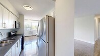Located at 350 The East Mall in Toronto's Etobicoke neighbourhood, this well-appointed 2-bedroom, 1-bathroom unit offers a functional and comfortable layout across a single floor. Gleaming parquet hardwood flooring flows throughout the living, dining, and bedroom areas, adding warmth and a classic character to the space.

The open-concept living and dining area is generously sized, bathed in natural light from a wide bank of windows that frame views of surrounding greenery. The kitchen is a standout feature, equipped with white cabinetry, stainless steel appliances including a fridge and range, a deep sink, and a large central island with a dark countertop — ideal for both cooking and casual dining.

Both bedrooms are well-proportioned, each with polished parquet floors, windows overlooking outdoor greenery, and baseboard heating. The primary bedroom includes a sliding mirrored closet, enhancing the sense of space and providing practical storage. The second bedroom is bright and versatile.

The bathroom is finished with neutral-toned wall tiles, a soaker tub with shower, a modern vanity with dark countertop, and clean tile flooring — offering a fresh, updated aesthetic. Throughout the unit, white walls and abundant natural light create a bright, airy ambiance suited to a variety of living styles.