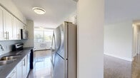 Located at 350 The East Mall in Toronto's Etobicoke neighbourhood, this well-appointed 2-bedroom, 1-bathroom unit offers a functional and comfortable layout across a single floor. Gleaming parquet hardwood flooring flows throughout the living, dining, and bedroom areas, adding warmth and a classic character to the space.

The open-concept living and dining area is generously sized, bathed in natural light from a wide bank of windows that frame views of surrounding greenery. The kitchen is a standout feature, equipped with white cabinetry, stainless steel appliances including a fridge and range, a deep sink, and a large central island with a dark countertop — ideal for both cooking and casual dining.

Both bedrooms are well-proportioned, each with polished parquet floors, windows overlooking outdoor greenery, and baseboard heating. The primary bedroom includes a sliding mirrored closet, enhancing the sense of space and providing practical storage. The second bedroom is bright and versatile.

The bathroom is finished with neutral-toned wall tiles, a soaker tub with shower, a modern vanity with dark countertop, and clean tile flooring — offering a fresh, updated aesthetic. Throughout the unit, white walls and abundant natural light create a bright, airy ambiance suited to a variety of living styles.