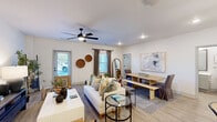 Located at 15 Pasture St in Okatie, SC, this single-story, 3-bedroom, 2-bathroom home offers a thoughtfully designed open-concept layout with modern finishes throughout. Light wood-look flooring flows seamlessly through the main living areas, complementing the bright, neutral color palette and recessed lighting.

The kitchen is a standout feature, boasting white shaker-style cabinetry, stainless steel appliances including a French door refrigerator, electric range, and microwave, as well as a large center island with a white quartz countertop, undermount sink, and pendant lighting — ideal for both cooking and casual dining.

The open living and dining area is bright and welcoming, with multiple windows providing ample natural light, a ceiling fan, and direct access to an exterior door. The primary bedroom is a comfortable retreat with a ceiling fan and windows overlooking the outdoors. Additional bedrooms feature ceiling fans, natural light, and wood-look flooring. Both bathrooms are finished with gray shaker vanities, framed mirrors, and light tile flooring. A dedicated laundry room houses a full-size Whirlpool washer and dryer. The home also includes a closet and smart home panel for added convenience.