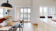Located at 1819 Avenue Dollard in LaSalle, Montréal, this well-appointed 3-bedroom, 1-bathroom unit offers a thoughtfully designed single-floor layout. A defining architectural feature throughout is the exposed concrete ceiling, which lends an industrial-modern character to every room, complemented by light hardwood flooring that runs seamlessly across the space.

The open-concept kitchen and dining area serves as the heart of the unit. The kitchen features light wood cabinetry paired with white upper cabinets, a large central island with a quartz countertop and bar seating, stainless steel appliances, and matte black fixtures. Pendant lighting adds a contemporary touch overhead. Sliding glass doors open directly from the dining area onto a private balcony, bringing in abundant natural light and views of the surrounding Montréal streetscape.

Each of the three bedrooms benefits from large windows that frame outdoor views and fill the rooms with daylight. The primary bedroom is a comfortable retreat with a built-in closet and ample space. The bathroom is finished with large-format terrazzo-style floor tiles, a clean white vanity, and matte black hardware accents that echo the design language found throughout the unit. A dedicated closet provides additional storage. The overall ambiance is bright, modern, and cohesive.