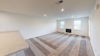 Located at 201 Shrewsbury Ct in Dover, Delaware, this single-floor residence offers a practical and comfortable layout with well-defined living spaces throughout. A long, hardwood-floored hallway connects the main areas of the home, providing a clean and organized flow from room to room.

The spacious living room is a standout feature, boasting recessed lighting, plush carpeting, and a classic fireplace framed by two windows that allow natural light to fill the space. Adjacent to the living area, the open-concept kitchen features rich, dark cherry wood cabinetry, light-toned countertops, and black appliances including a range, over-the-range microwave, and refrigerator, all complemented by a breakfast bar that connects seamlessly to the living space.

The bedrooms are carpeted for comfort, with one room featuring a walk-in closet with built-in shelving. The bathrooms are finished with tile flooring, cherry wood vanities, white countertops, and a walk-in shower with built-in shelving. A dedicated laundry room houses a full-size washer and dryer set alongside wire shelving and tile flooring, adding everyday convenience. The home presents a clean, neutral palette throughout, making it a versatile and move-in ready space.