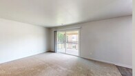 Located at 372 Beechmont Dr in Newport News, VA, this single-floor, 3-bedroom, 1-bathroom home offers a practical and well-organized layout. The living room is a bright, open space featuring plush carpeting and a large sliding glass door that leads to a private balcony, filling the room with natural light and providing outdoor views. Adjacent to the living area, the kitchen is equipped with white cabinetry, light countertops, wood-look vinyl flooring, and black appliances including a refrigerator and range, complemented by an under-cabinet range hood. A separate dining room provides a defined space for meals. The three bedrooms are carpeted and feature neutral walls, with windows fitted with blinds allowing for adjustable natural light. The generously sized primary bedroom offers comfortable proportions, while the additional bedrooms are well-suited for various uses. Four closets throughout the home provide excellent storage capacity. The full bathroom features white subway tile surrounding a tub-shower combination, wood-look vinyl flooring, a pedestal sink, and a large mirror. Hallways connect the rooms efficiently, contributing to a cohesive and easy-to-navigate floor plan throughout this Newport News residence.
