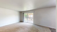 Located at 372 Beechmont Dr in Newport News, VA, this single-floor, 3-bedroom, 1-bathroom home offers a practical and well-organized layout. The living room is a bright, open space featuring plush carpeting and a large sliding glass door that leads to a private balcony, filling the room with natural light and providing outdoor views. Adjacent to the living area, the kitchen is equipped with white cabinetry, light countertops, wood-look vinyl flooring, and black appliances including a refrigerator and range, complemented by an under-cabinet range hood. A separate dining room provides a defined space for meals. The three bedrooms are carpeted and feature neutral walls, with windows fitted with blinds allowing for adjustable natural light. The generously sized primary bedroom offers comfortable proportions, while the additional bedrooms are well-suited for various uses. Four closets throughout the home provide excellent storage capacity. The full bathroom features white subway tile surrounding a tub-shower combination, wood-look vinyl flooring, a pedestal sink, and a large mirror. Hallways connect the rooms efficiently, contributing to a cohesive and easy-to-navigate floor plan throughout this Newport News residence.