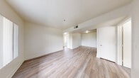 Located on Las Vegas Boulevard North in North Las Vegas, this 3-bedroom, 2-bathroom residence offers a practical and well-organized single-floor layout. The galley-style kitchen is a standout feature, equipped with dark espresso cabinetry, granite-look countertops, a tile mosaic backsplash, black appliances including a gas range and refrigerator, and durable wood-look flooring — providing both function and visual contrast. The living room is bright and open, featuring the same wood-look flooring that runs throughout the main living areas, a large window with vertical blinds that invites natural light, and direct access to the front entry. Each of the three bedrooms is finished with plush carpeting and windows that bring in outdoor views and daylight. The primary bedroom includes a full-width sliding closet for generous storage. The two bathrooms are clean and functional, both featuring wood-look tile flooring, dark-cabinetry vanities with granite-look countertops, and large mirrors. One bathroom includes a full tub-shower combination, while the second features a high transom window for added natural light. The overall aesthetic is neutral and move-in ready, with a consistent palette of whites and warm tones throughout.