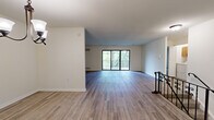 Located at 206 N President Ave in Lancaster, PA, this well-appointed two-bedroom, two-bathroom unit offers a thoughtfully designed single-floor layout spanning a generously sized living area. Accessed via a staircase framed by an ornate wrought iron railing with decorative scrollwork, the main living space features light-toned hardwood-style flooring and crisp white walls that create a bright, clean atmosphere throughout.

The open living and dining areas are anchored by elegant chandelier lighting, with the living space offering sliding glass doors that open to a private balcony, filling the room with natural light and outdoor views. The dining area features its own chandelier and continues the cohesive hardwood-style flooring.

The kitchen is well-equipped with warm honey-toned cabinetry, granite countertops, a subway tile backsplash, stainless steel sink, and black appliances including a dishwasher and refrigerator.

Both bedrooms are carpeted and receive ample natural light through large windows. The spacious primary bedroom features multiple windows with views of surrounding greenery. The two bathrooms are finished with marble-look tile flooring, warm wood vanities, and clean white fixtures, with one bath featuring a walk-in shower stall.