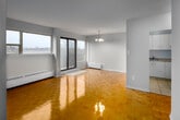 This one-bedroom, one-bathroom unit at 39 Brookwell Dr in Toronto's M3M neighbourhood offers a functional and well-laid-out living space. The combined living and dining area is the centerpiece of the unit, featuring warm parquet hardwood flooring that extends throughout most of the space. A large picture window and sliding glass door flood the room with natural light and provide direct access to a private balcony with outdoor views. A chandelier pendant light adds a decorative touch to the dining area.

The kitchen is efficiently designed with a U-shaped layout, featuring white cabinetry with ample upper and lower storage, a countertop with an undermount sink, and light tile flooring. White appliances including a refrigerator and stove are included.

The bedroom is a comfortable size, benefiting from two windows that allow generous natural light and outdoor views. It includes a built-in sliding door closet offering dedicated storage space. Baseboard heating units are present in both the living area and bedroom.

The bathroom is clean and straightforward, featuring a tiled tub-surround, a vanity with mirror, and light tile flooring. The unit also includes an additional closet, providing extra storage capacity throughout.