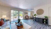 Located in Lakeland, Florida, this single-story home on Thomasville Circle offers a well-organized floor plan designed for comfortable everyday living. The main living area is bright and open, featuring wood-look hard flooring and a textured ceiling. A large sliding glass door fitted with vertical blinds provides direct access to a private patio and frames views of mature, lush greenery, filling the space with abundant natural light. An additional window further enhances the airy feel of the room.

The dining area is positioned adjacent to the living space, offering its own window with natural light and wood-look flooring, creating a welcoming setting for meals. The kitchen is equipped with light wood cabinetry, a countertop peninsula, a double basin sink, dishwasher, refrigerator, and the added convenience of an in-unit stacked washer and dryer.

The bedroom features plush wall-to-wall carpeting and a window that brings in natural light, providing a calm and comfortable retreat. The bathroom includes a tub-shower combination, wood-look flooring, and a vanity with a light countertop surface. Throughout the home, neutral tones and consistent finishes contribute to a cohesive and inviting atmosphere.