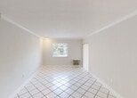 Located at 8800 SW 68 Ct in the desirable Pinecrest neighborhood of Miami-Dade County, this single-story unit offers a clean, functional layout designed for comfortable everyday living. The main living area is bright and open, featuring large white square floor tiles, crown molding, and a window with blinds that allows natural light to filter in. A wall-mounted air conditioning unit provides climate control directly within the space.

The kitchen is well-appointed with warm wood cabinetry, dark soapstone-style countertops, stainless steel appliances including an electric range, over-the-range microwave, and dishwasher. A peninsula with a dark countertop and pendant lighting above it connects the kitchen to the living and dining area, making it ideal for casual dining or entertaining.

The bedroom features light wood-look laminate flooring, soft neutral walls, track lighting, and a mirrored sliding closet door that adds depth and reflectivity to the room. Natural light enters through a window, keeping the space feeling airy.

The full bathroom includes a tub and shower combination, brushed nickel fixtures and grab bar, a toilet, and a vanity with a dark countertop, maintaining the consistent design palette found throughout the unit. The overall ambiance is clean, minimal, and move-in ready.