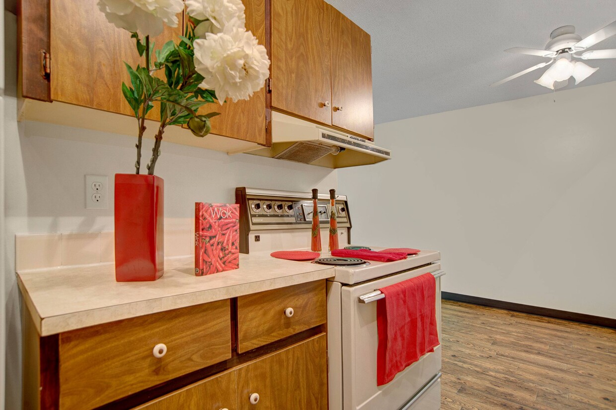 A kitchen with white appliances and wood cabinetry - Edgemont Heights