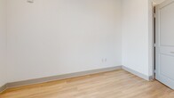 This contemporary 650 square foot apartment in Baton Rouge combines efficiency with style in a single-floor layout. The open-concept design seamlessly integrates the kitchen, living, and dining areas, creating a spacious feel. The kitchen is a highlight, boasting white cabinetry, granite countertops, and stainless steel appliances including a refrigerator, stove, and over-the-range microwave. 

The bathroom features a large vanity with granite countertop, ample storage, and a well-lit mirror. The bedroom, measuring 150 square feet, offers a comfortable retreat with a sizeable closet for storage. Throughout the apartment, light wood-look flooring adds warmth and continuity.

Large windows in the living area and bedroom flood the space with natural light and provide pleasant views. The neutral color palette, dominated by whites and light grays, creates a clean, modern aesthetic. Thoughtful details such as recessed lighting and a programmable thermostat enhance the overall comfort and functionality of this contemporary living space.