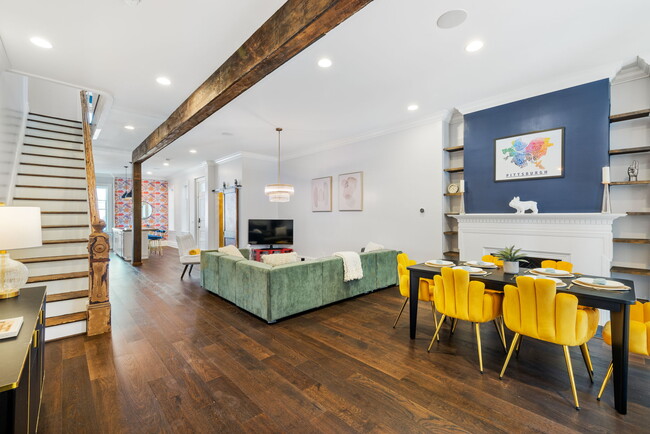 An inviting open-concept space seamlessly blending the living room and dining area, creating a harmo - 5311 Carnegie St