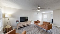 Located in Crowley, TX, this two-story home offers 2 bedrooms and 3 bathrooms across two well-proportioned floors. The main level features a welcoming living room with wood-look plank flooring, neutral gray walls, a ceiling fan, and a window that invites natural light. The galley-style kitchen is thoughtfully designed with gray cabinetry, granite-style countertops, a subway tile backsplash, a double sink, and black appliances including a refrigerator, range, and dishwasher. A staircase connects the main level to the upper floor, which houses the bedrooms and additional bathrooms. The spacious primary bedroom features wood-look flooring, a ceiling fan with light kit, and a window with outdoor views. The second bedroom offers a clean, neutral palette with matching flooring. All three bathrooms are consistently appointed with gray vanity cabinets, granite-style countertops, large mirrors, and modern brushed-nickel fixtures. At least one bathroom includes a shower-tub combination. Textured ceilings are featured throughout the home. The exterior reveals a modest yard with surrounding greenery, providing a private outdoor setting. The home combines practical functionality with a cohesive, contemporary aesthetic throughout.