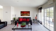 Located at 301 E Renaissance Blvd in North Brunswick, NJ, this two-story, 3-bedroom, 2.5-bathroom home offers a functional and well-designed layout across two floors. The main level features a carpeted living room with large sliding glass doors that invite natural light, alongside a dedicated dining area illuminated by a chandelier and brightened by wide windows with blinds. The kitchen is equipped with warm honey-toned cabinetry, granite countertops, stainless steel appliances including a gas range, built-in microwave, refrigerator, and dishwasher, all set over clean tile flooring. A convenient half-bath on the main level features tile flooring and crisp white finishes. Upstairs, the generously sized primary bedroom offers plush carpeting and ample natural light through large windows. Two additional bedrooms, each carpeted and naturally lit, provide flexible living options. A full bathroom features neutral tile, a tub-shower combination, and tile flooring. The home's interior is characterized by neutral walls, consistent carpeting throughout the upper level, and an open, airy ambiance that flows naturally between spaces.