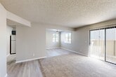 Located in Atascadero, California, this single-story 2-bedroom, 2-bathroom home offers a practical and comfortable layout designed for everyday living. The open living area features plush carpeting underfoot and a textured ceiling, with a sliding glass door fitted with vertical blinds that brings in natural light and provides outdoor access. The space flows seamlessly into a dining area, which is illuminated by a ceiling fan and benefits from natural light through a double window. The kitchen is outfitted with gray shaker-style cabinetry, light stone-look countertops, light wood-style flooring, recessed lighting, and stainless steel appliances including a refrigerator and dishwasher. Both bedrooms are carpeted and offer ample closet storage, with the primary bedroom featuring a double sliding closet for added convenience. The two bathrooms are finished with gray vanity cabinetry, brushed nickel hardware, stone-look countertops, a large mirror, and light wood-style flooring. A dedicated utility room provides additional functional space. Throughout the home, a neutral color palette of warm beige and gray tones creates a clean, cohesive, and move-in-ready atmosphere.