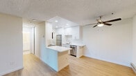 Located at 2850 Middlefield Rd in Palo Alto, California, this one-bedroom, one-bathroom unit offers a well-organized single-floor layout with clean, modern finishes throughout. Light wood-tone flooring runs continuously across the living spaces, complementing the neutral white walls and textured ceilings.

The open living and dining area is bright and welcoming, anchored by sliding glass doors that lead to a private balcony with outdoor views. A wall-mounted HVAC unit and baseboard heating provide year-round comfort, while recessed ceiling fans add to the functionality of the space.

The kitchen has been thoughtfully updated with white shaker-style cabinetry, quartz countertops, a subway tile backsplash, stainless steel appliances including a refrigerator, dishwasher, and range, and a built-in breakfast bar that doubles as additional prep space. Recessed lighting keeps the kitchen bright and practical.

The bedroom is a comfortable, well-proportioned room featuring a large sliding-door closet offering generous storage, a window that lets in natural light, and baseboard heating. The bathroom is finished in a clean, minimalist style with tile flooring, a quartz vanity, and a subway-tiled shower area. An in-unit laundry area is also visible within the kitchen corridor.