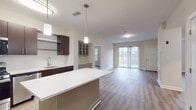 This contemporary 1050 square foot apartment in Norwood, MA offers a harmonious blend of style and functionality. The open-concept living area seamlessly integrates the kitchen and living room, creating an inviting space for relaxation and entertainment. The gourmet kitchen boasts sleek dark wood cabinetry, stainless steel appliances, and a convenient island, perfect for meal preparation and casual dining.

Two well-appointed bedrooms, including a spacious 150 square foot primary bedroom, provide comfortable retreats. The apartment features two modern bathrooms, each equipped with essential fixtures and ample space. Generous closet space in both bedrooms and throughout the apartment ensures organized living.

Light wood-look flooring runs throughout, complementing the neutral wall tones and creating a bright, airy atmosphere. Large windows in the bedrooms and living area allow natural light to flood the space, while offering picturesque views of the surrounding area. A private balcony accessible from the living room extends the living space outdoors, perfect for enjoying fresh air and scenic vistas.

The apartment's thoughtful design includes modern lighting fixtures, a central HVAC system for year-round comfort, and in-unit laundry facilities. With its blend of style, comfort, and convenience, this apartment offers an ideal living solution for those seeking a contemporary home in a desirable location.