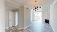 Located at 10125 Palms Blvd in the vibrant Palms neighborhood of Los Angeles, this thoughtfully designed single-floor residence blends modern aesthetics with comfortable living. The open living and dining area immediately impresses with soaring ceilings, light wood-style flooring, and crisp crown molding. A striking mid-century modern sputnik chandelier serves as a bold focal point, while a wall of sliding glass doors opens to a private balcony, flooding the space with abundant natural light and offering pleasant outdoor views of the surrounding neighborhood. The kitchen is outfitted with white shaker cabinetry, dark countertops, a mosaic tile backsplash, and a full suite of stainless steel appliances, including a gas range, built-in microwave, and refrigerator. The bedrooms are generously sized, featuring plush carpeting, soft neutral-toned walls, ceiling fans, crown molding, and plantation shutter windows that allow for natural light while maintaining privacy. The bathroom is well-appointed with a sliding glass shower enclosure over a tub and a vanity with dark countertops and white cabinetry. Throughout the residence, clean lines, neutral tones, and quality finishes create a bright, welcoming atmosphere ideal for comfortable urban living.