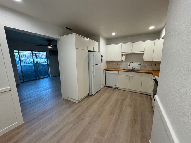 Bright open kitchen with tile backsplash and butcher block counter - 387 N 200 E