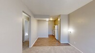 This 480 square foot apartment in Odessa, Texas offers a well-designed living space with two bedrooms and one bathroom. The single-story layout maximizes efficiency, featuring a living room, two bedrooms (including a 110 square foot primary bedroom), a bathroom, and a hallway connecting the spaces.

The interior boasts a neutral color palette with light gray walls, creating a bright and airy atmosphere. Plush carpeting in the bedrooms provides comfort underfoot, while wood-look flooring in the living area adds a touch of elegance. The living room features an air conditioning unit for climate control and benefits from natural light through a large window.

The bathroom is outfitted with white fixtures, including a bathtub with shower functionality, and is adorned with a patterned shower curtain. Throughout the apartment, recessed lighting and wall-mounted fixtures ensure ample illumination.

Storage options include a dedicated closet space, enhancing the apartment's functionality. The overall design prioritizes a clean, modern aesthetic with smooth walls and a textured ceiling. Despite its compact size, the apartment's thoughtful layout creates a sense of openness and flow between rooms, making it an ideal space for efficient, comfortable living.
